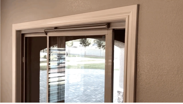 An auto-close sliding glass door